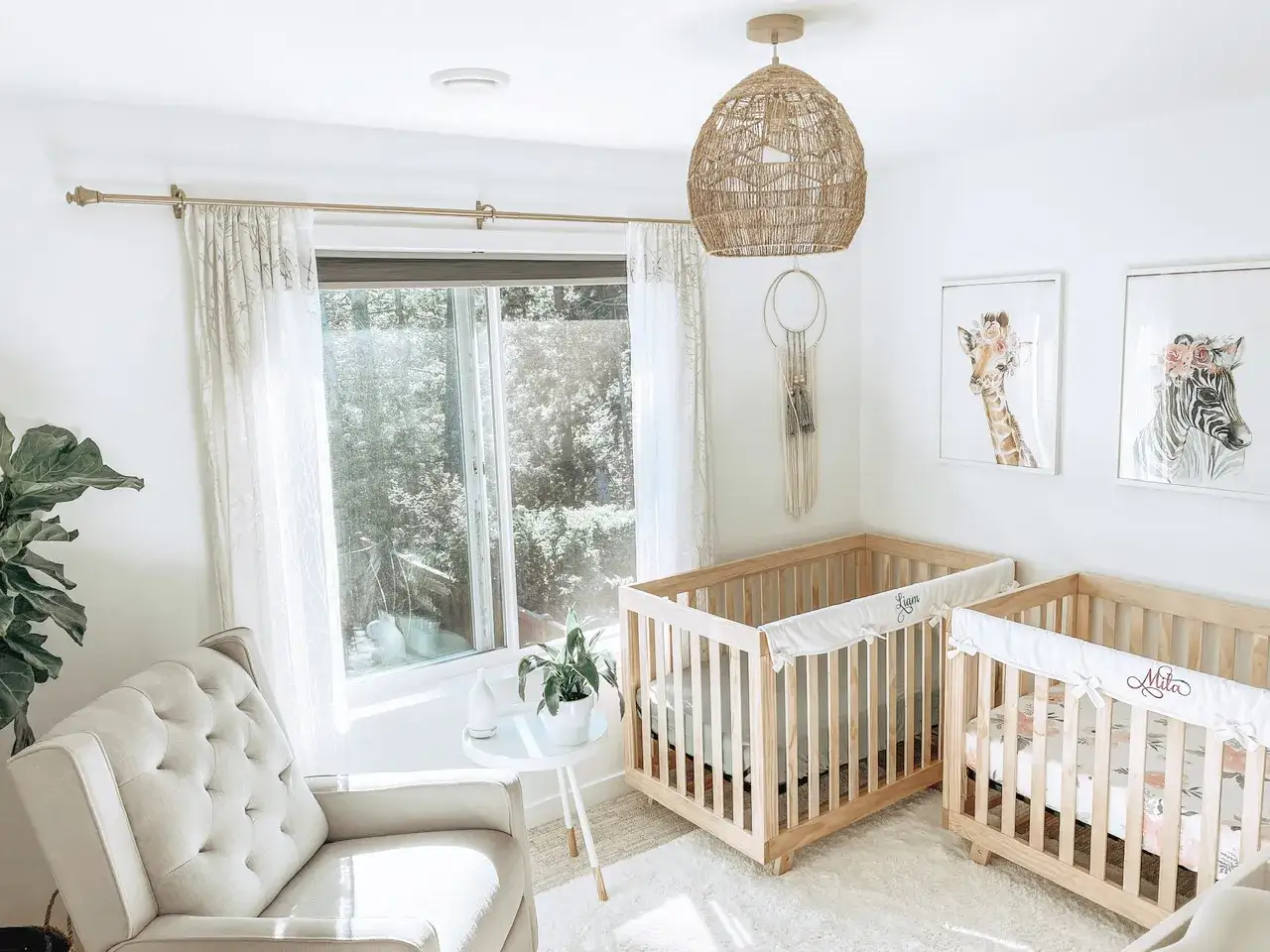 A bright nursery with a cozy armchair, a large window, and two wooden baby cribs, perfect for twin siblings.