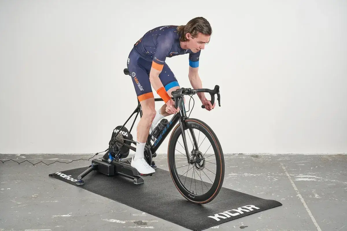 Cyclist on a trainer, focused on a VO2 max training program.