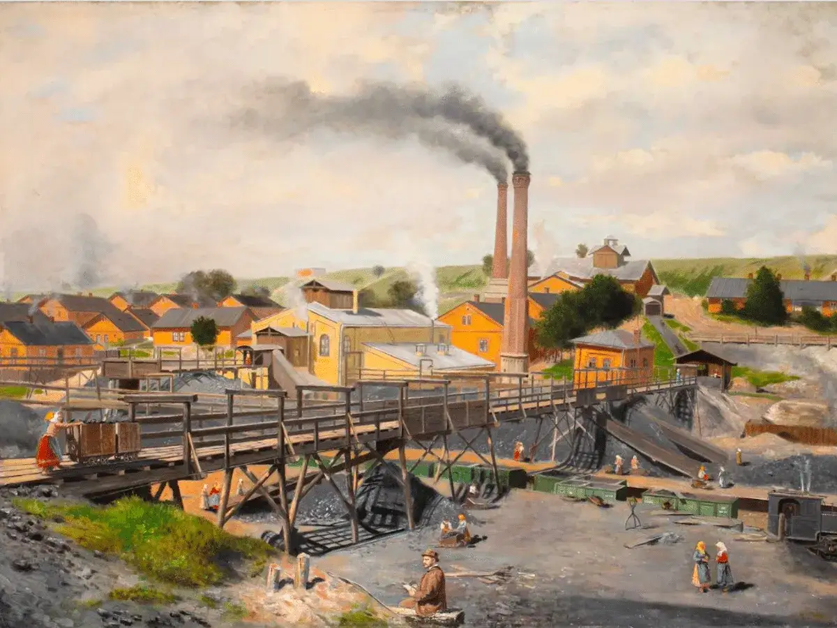 Una mina de carbón con chimeneas humeantes, que ilustra **que es la revolución industrial** y el trabajo en la época.