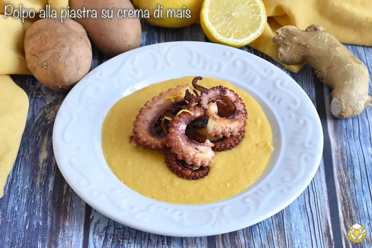 Pulpo a la plancha sobre crema de ma&iacute;z, adornado con ralladura de lim&oacute;n. Ingredientes frescos como patatas y jengibre acompa&ntilde;an el plato.