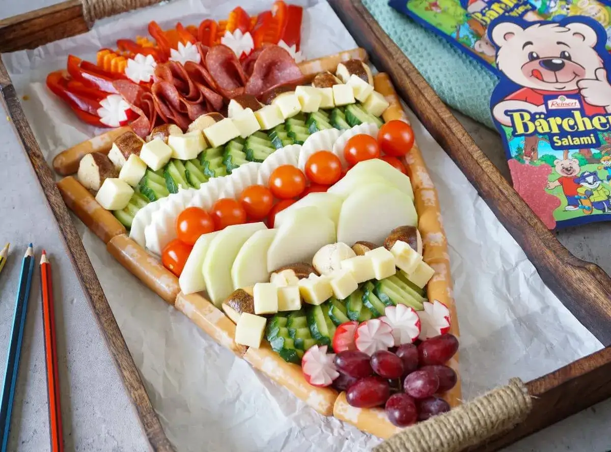 Buntes Buffet f&uuml;r die Einschulung: W&uuml;rstchen, K&auml;se, Gem&uuml;se und Obst in Tortenform. Perfekt f&uuml;r eine Gartenparty!