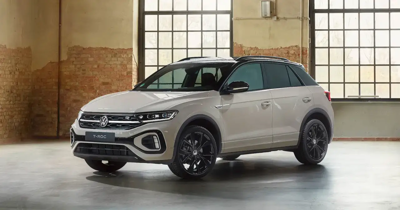 Nowy Volkswagen T-Roc w kolorze piaskowym, z czarnymi felgami i dachem. Sprawdź aktualną volkswagen t-roc cena.