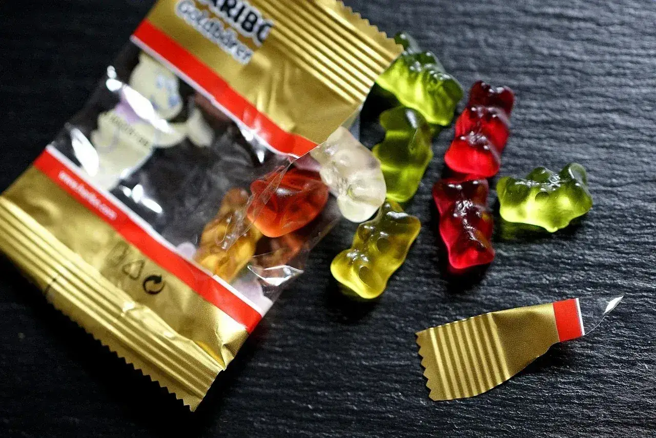 Osos de goma Haribo, algunos fuera de la bolsa dorada. ¡Cuidado, las gominolas caducan!