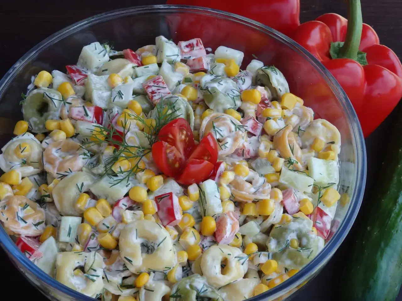 Kolorowa sałatka z tortellini, kukurydzą, papryką i og&oacute;rkiem, polana kremowym sosem.