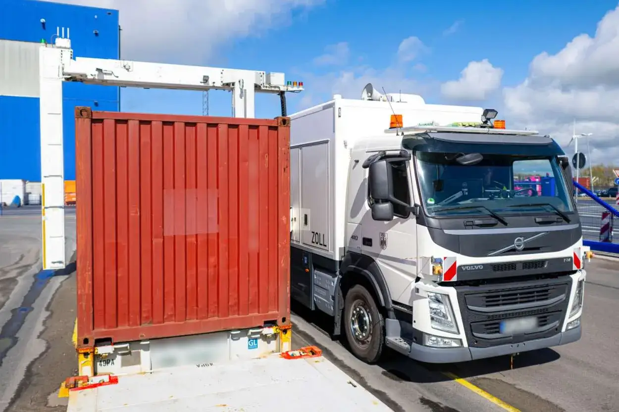 Ein Zoll-LKW mit einem roten Container, der f&uuml;r die Durchleuchtung bereitsteht.
