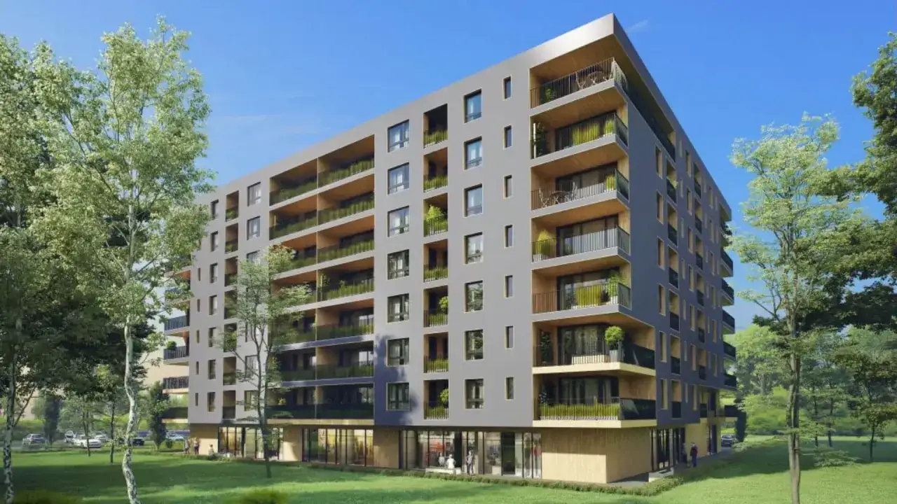 Nowoczesny budynek mieszkalny z licznymi balkonami, otoczony zielenią. Czy każdy balkon będzie obciążony podatkiem?