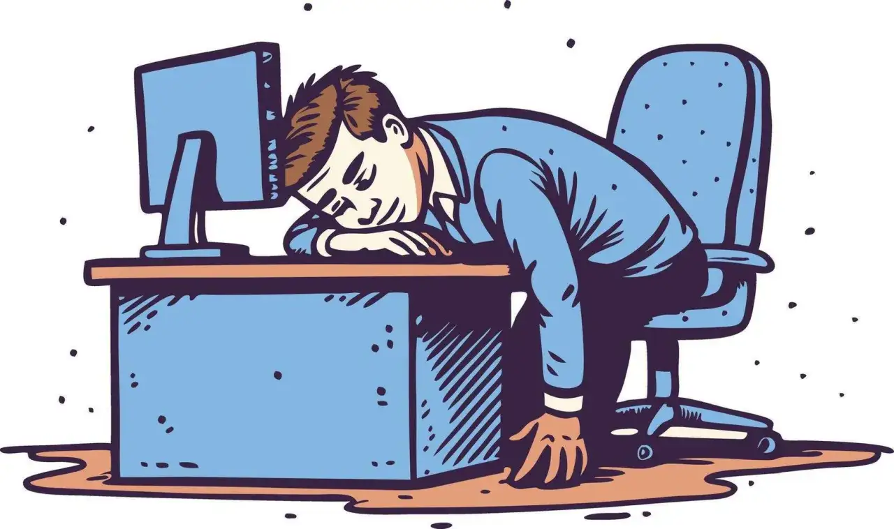 Mann schl&auml;ft am Schreibtisch ein, Kopf auf den Armen, ein Bild f&uuml;r stillen Burnout.