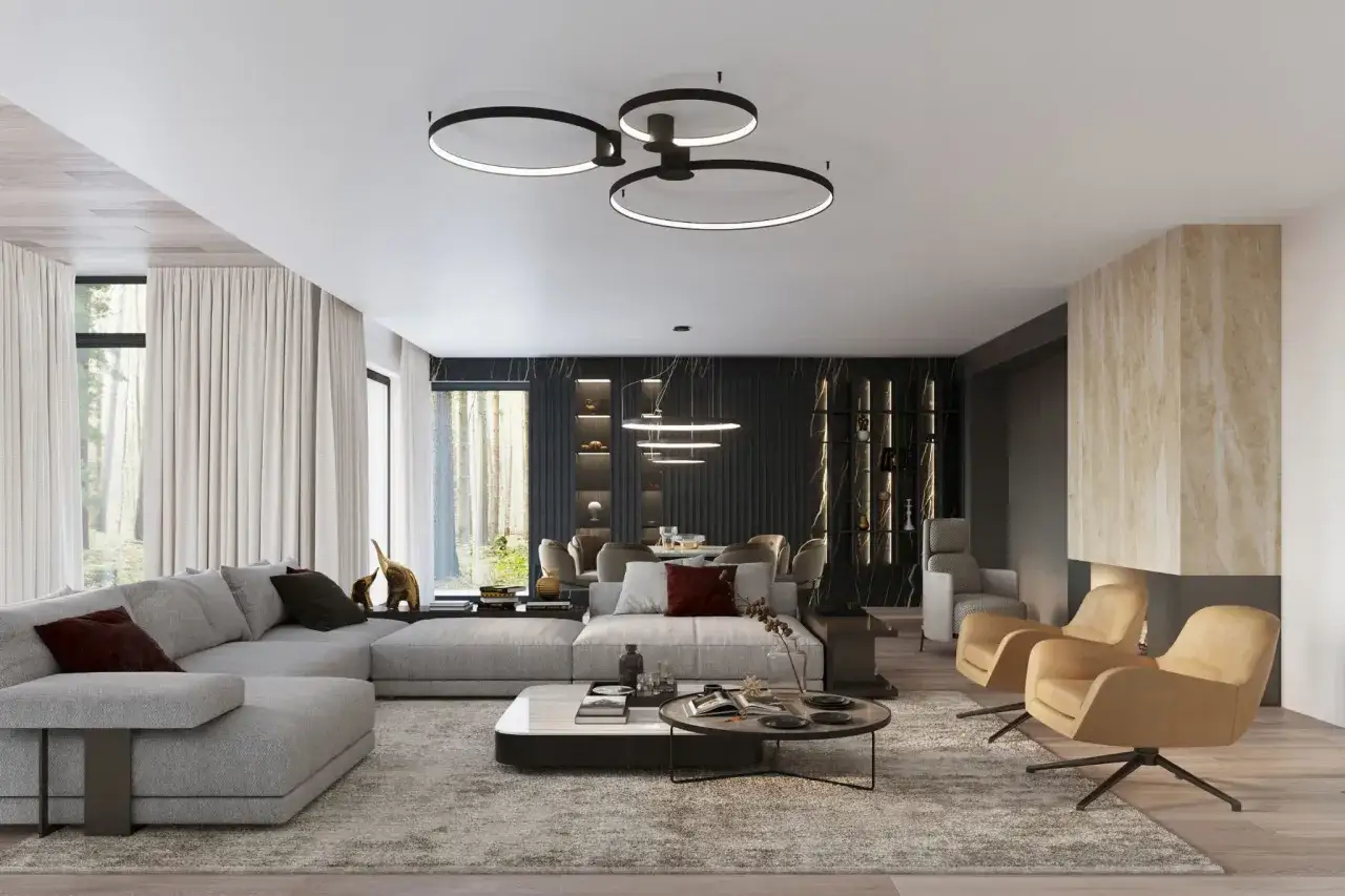 Nowoczesny plafon w salonie, który dopełnia eleganckie aranżacje. Duża, szara sofa, designerskie fotele i kamienny kominek tworzą przytulną przestrzeń.