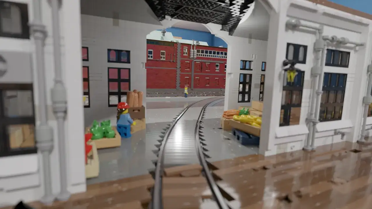 Kolejka z klocków Lego wjeżdża do hali. Zobacz, jak zbudować coś z Lego, tworząc tę scenę z pociągiem i budynkami.