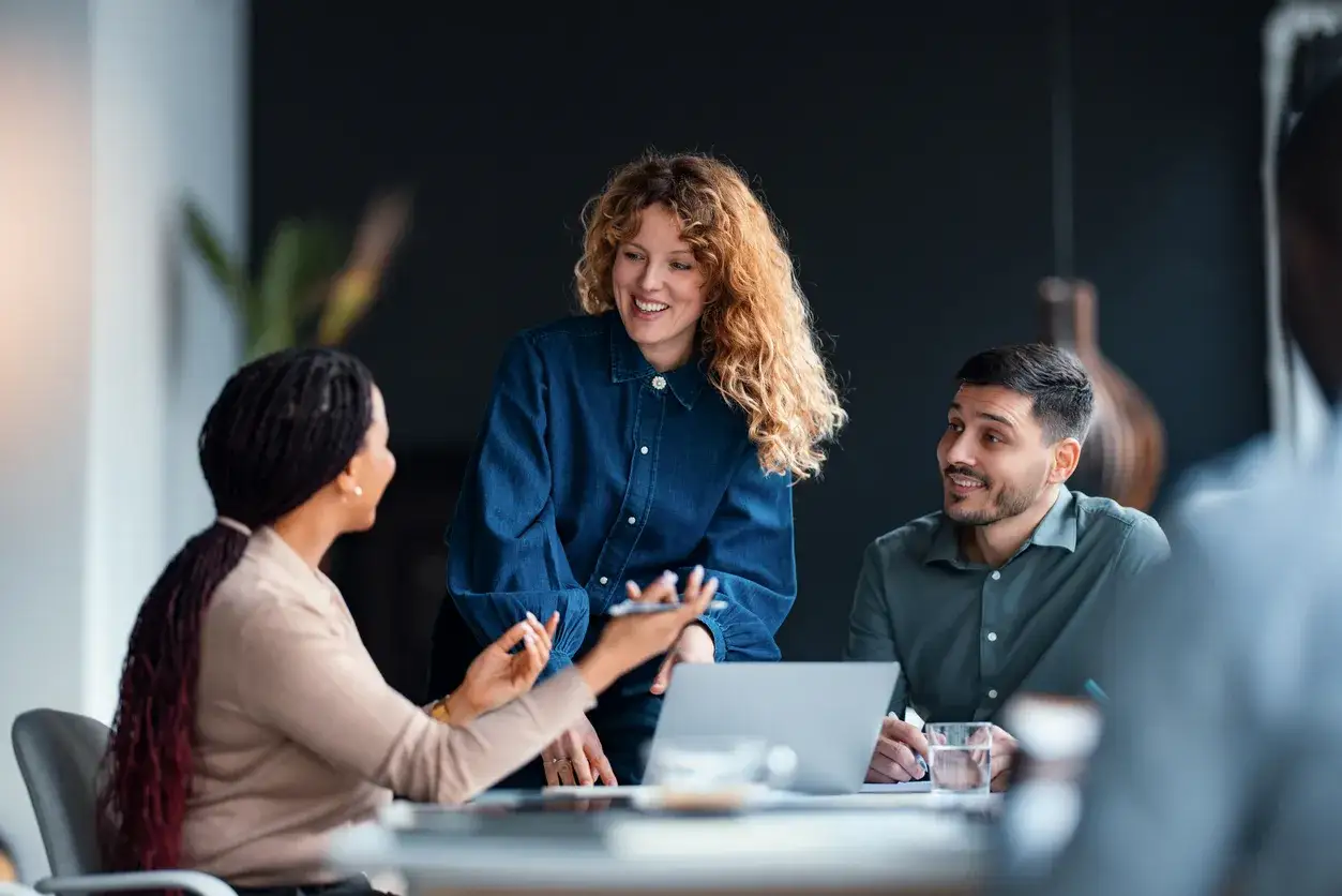A diverse team engages in a lively discussion, a key moment in their leadership development coaching session.