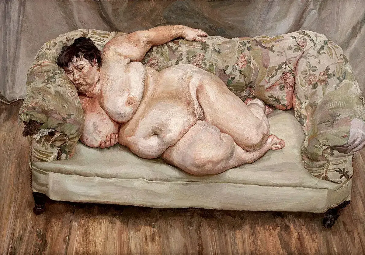 Un desnudo de Lucian Freud, una figura voluminosa reposa en un sofá floral, su cuerpo capturado con una intensidad cruda.
