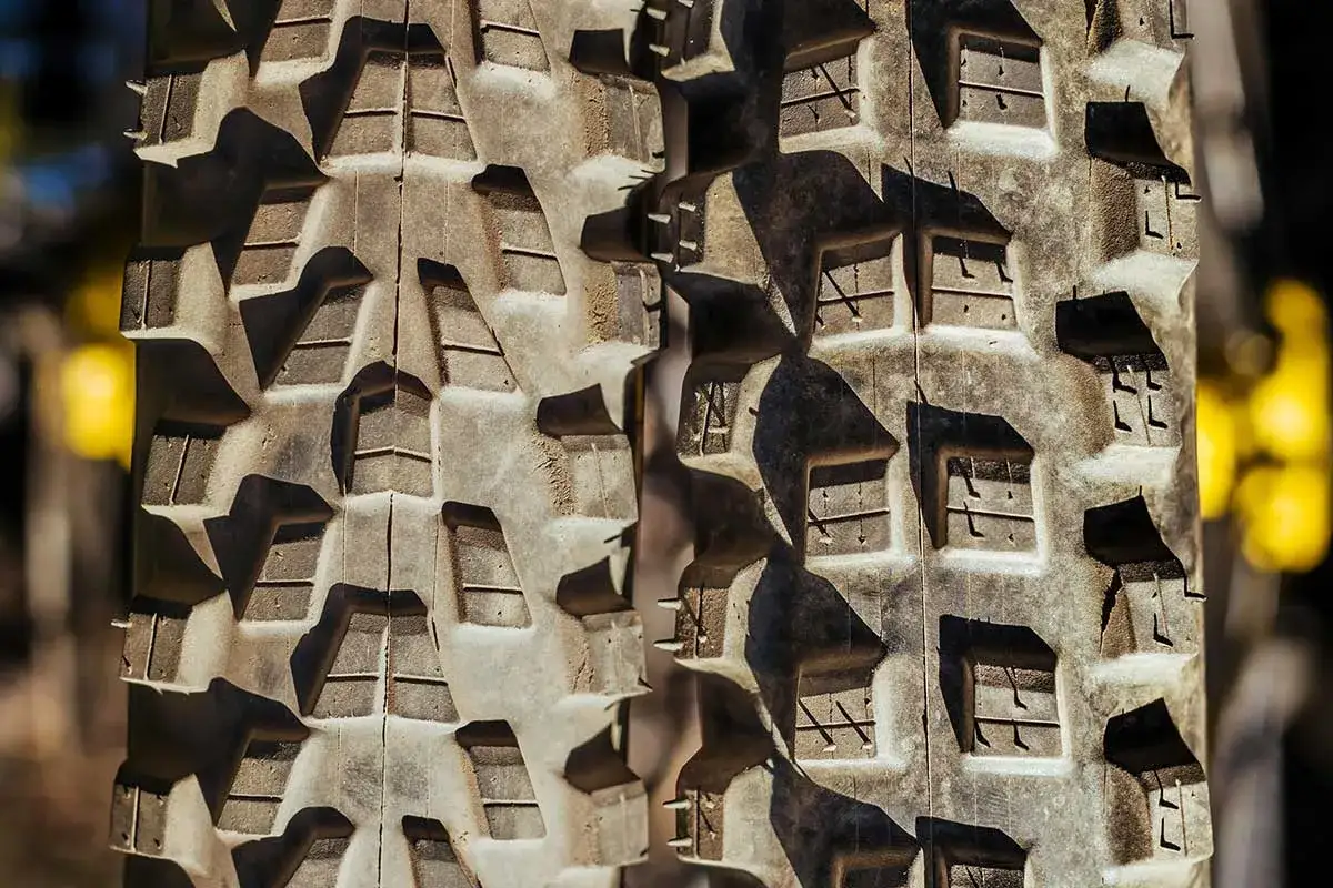Close-up of the aggressive tread pattern of a Michelin Force AM2 tire, ready to grip any trail.