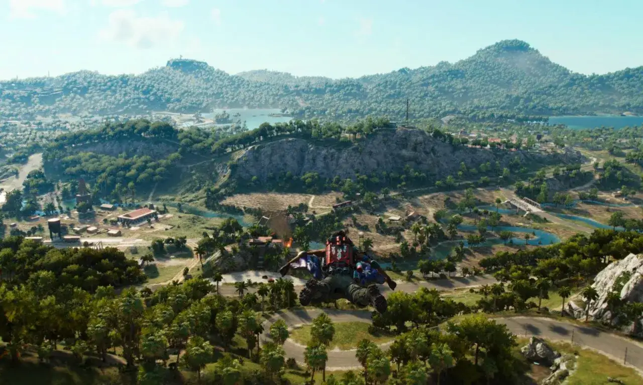 Gracz w wingsuicie nad tropikalną wyspą, idealne miejsce na eksplorację w Far Cry 6 poradnik.