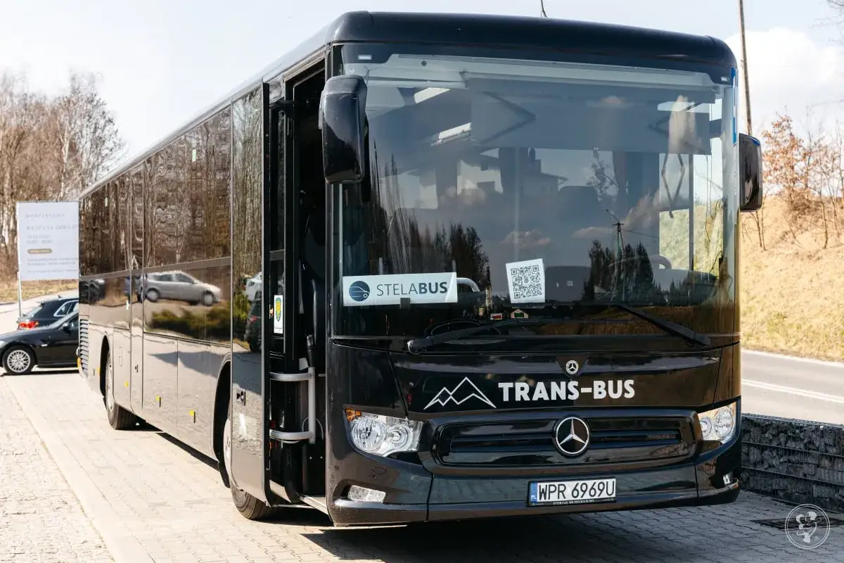 Czarny autobus TRANS-BUS czeka na transport gości weselnych. Drzwi otwarte, gotowy do drogi.