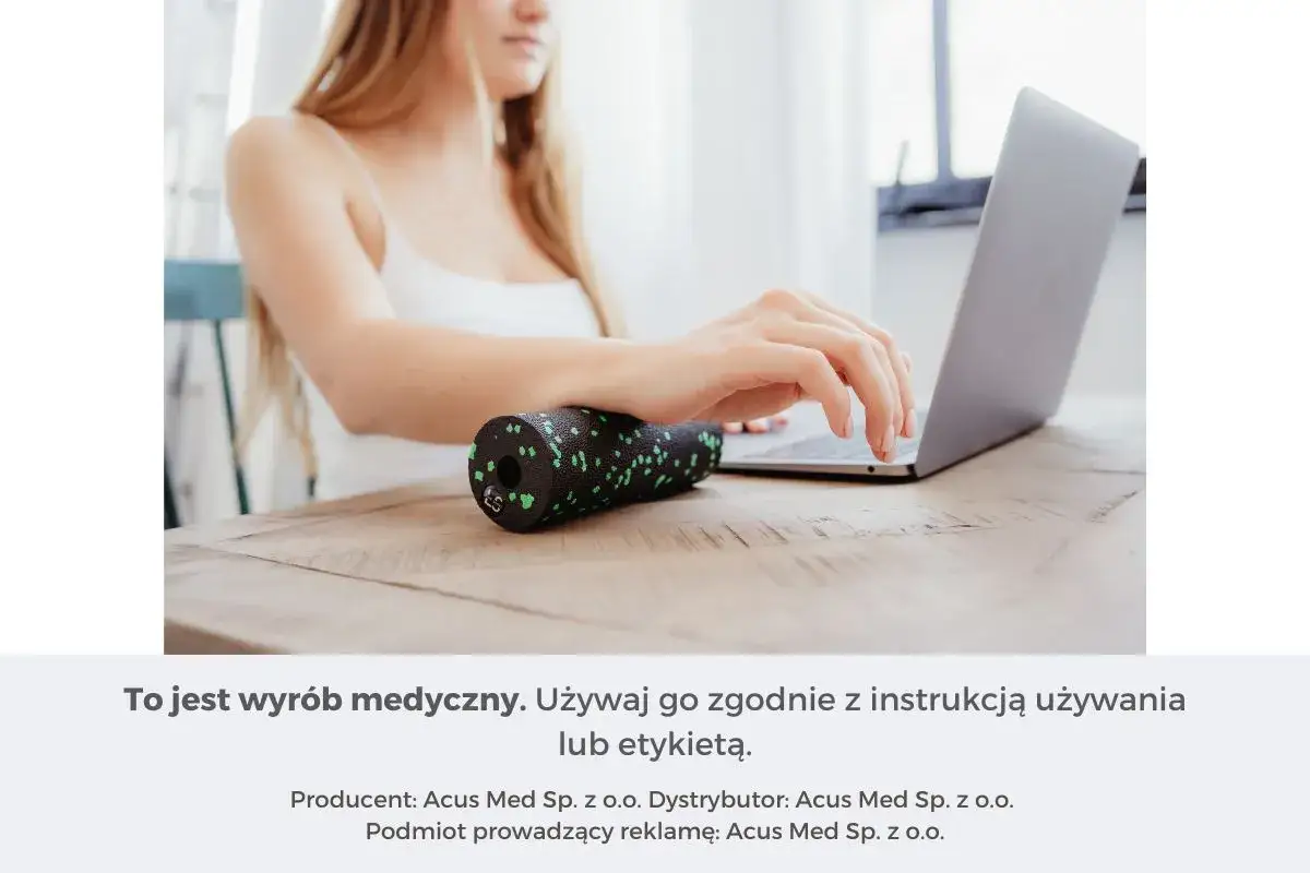 Kobieta pracuje przy laptopie, a obok niej leży wałek do masażu, kt&oacute;ry może pom&oacute;c w łagodzeniu objaw&oacute;w zespołu cieśni nadgarstka.