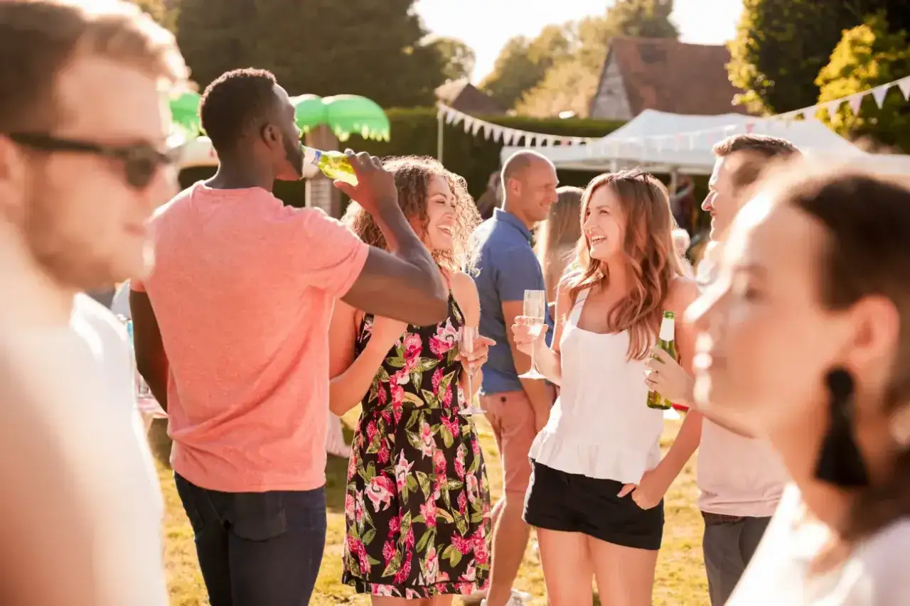 Friends enjoying a garden party, a perfect setting for brainstorming april fundraising ideas.