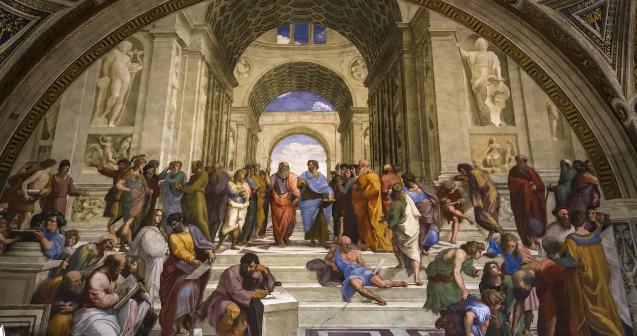 La Escuela de Atenas, una de las obras maestras de Rafael Sanzio, muestra a filósofos discutiendo en un gran edificio clásico.