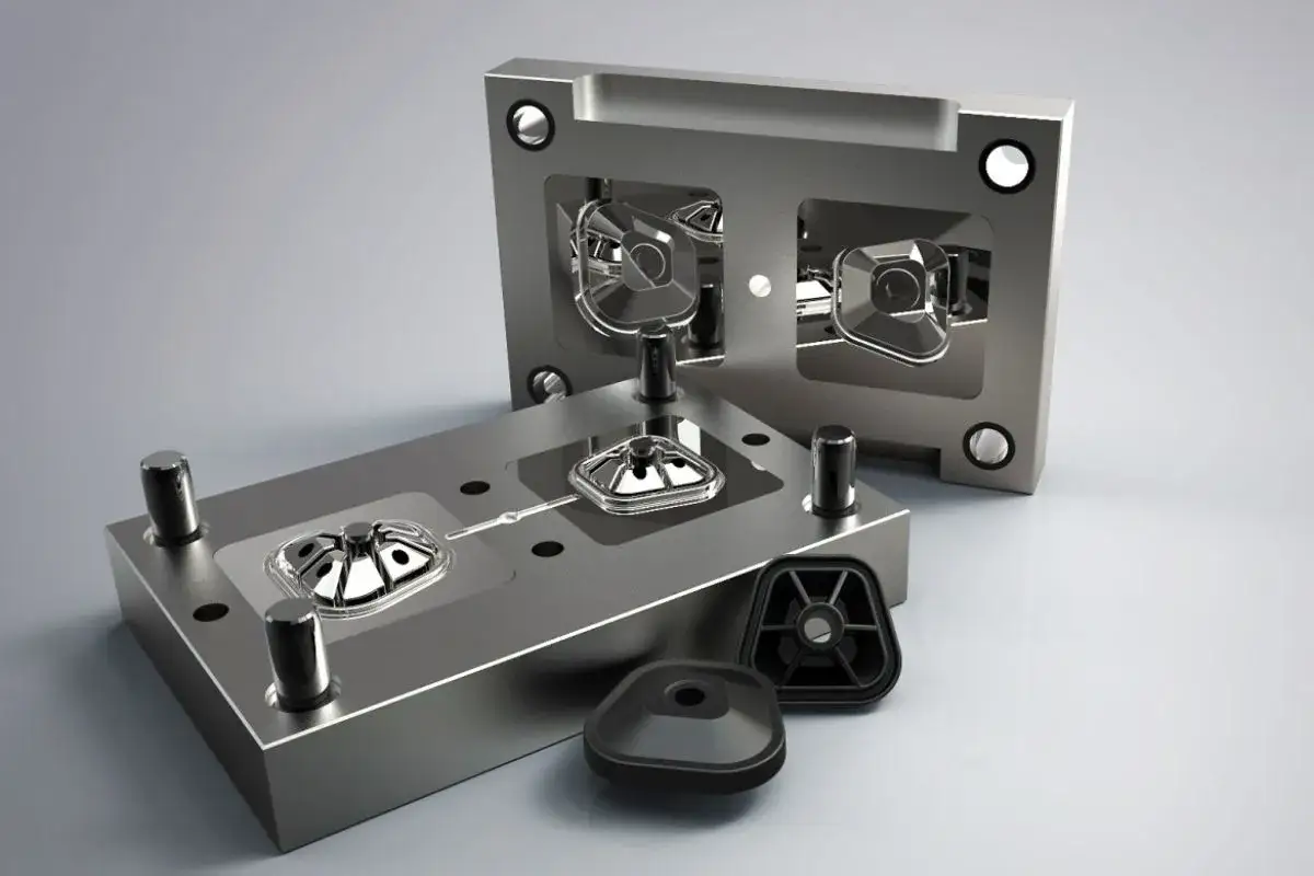 Two halves of a metal mold for rapid tooling, with shiny plastic parts ready for assembly.