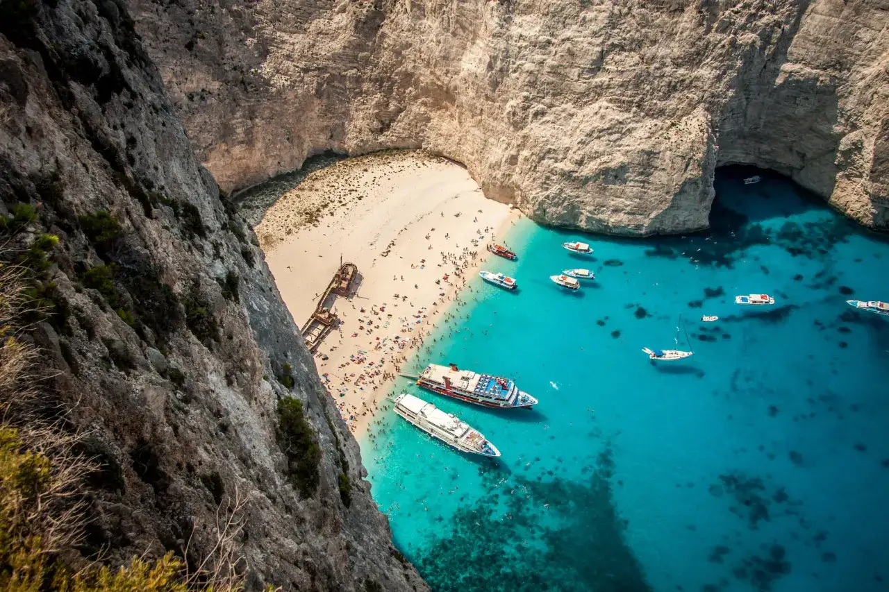 W Grecji jest Morze Jońskie, które jest częścią Oceanu Atlantyckiego. Widok na plażę Navagio z klifu, z turystami i statkami.
