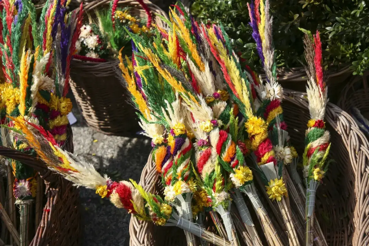 Kolorowe palmy wielkanocne w wiklinowych koszach. Zastanawiasz się, co zrobić z palmą wielkanocną? Te piękne ozdoby to symbol tradycji.