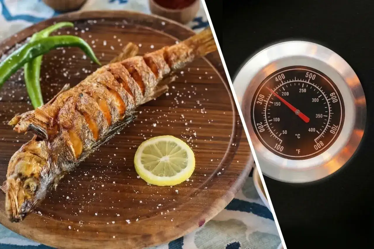 Złocista ryba z grilla, doprawiona solą i cytryną, obok termometr piekarnika wskazujący 200°C.