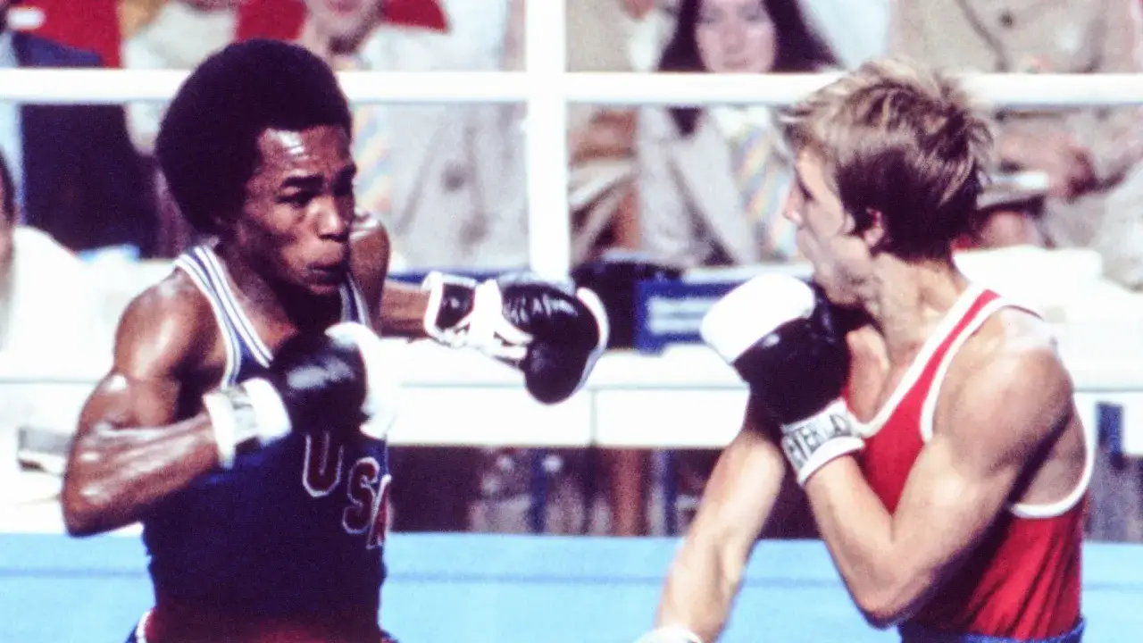Sugar Ray Leonard, a boxing legend, throws a punch. His career earnings are a testament to his skill, but this image captures his Olympic glory.