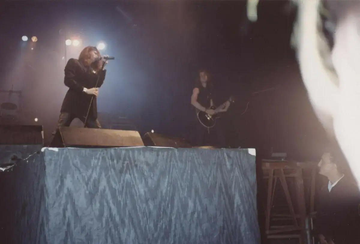 I **heroes del silencio** sul palco, un cantante con microfono e un chitarrista.