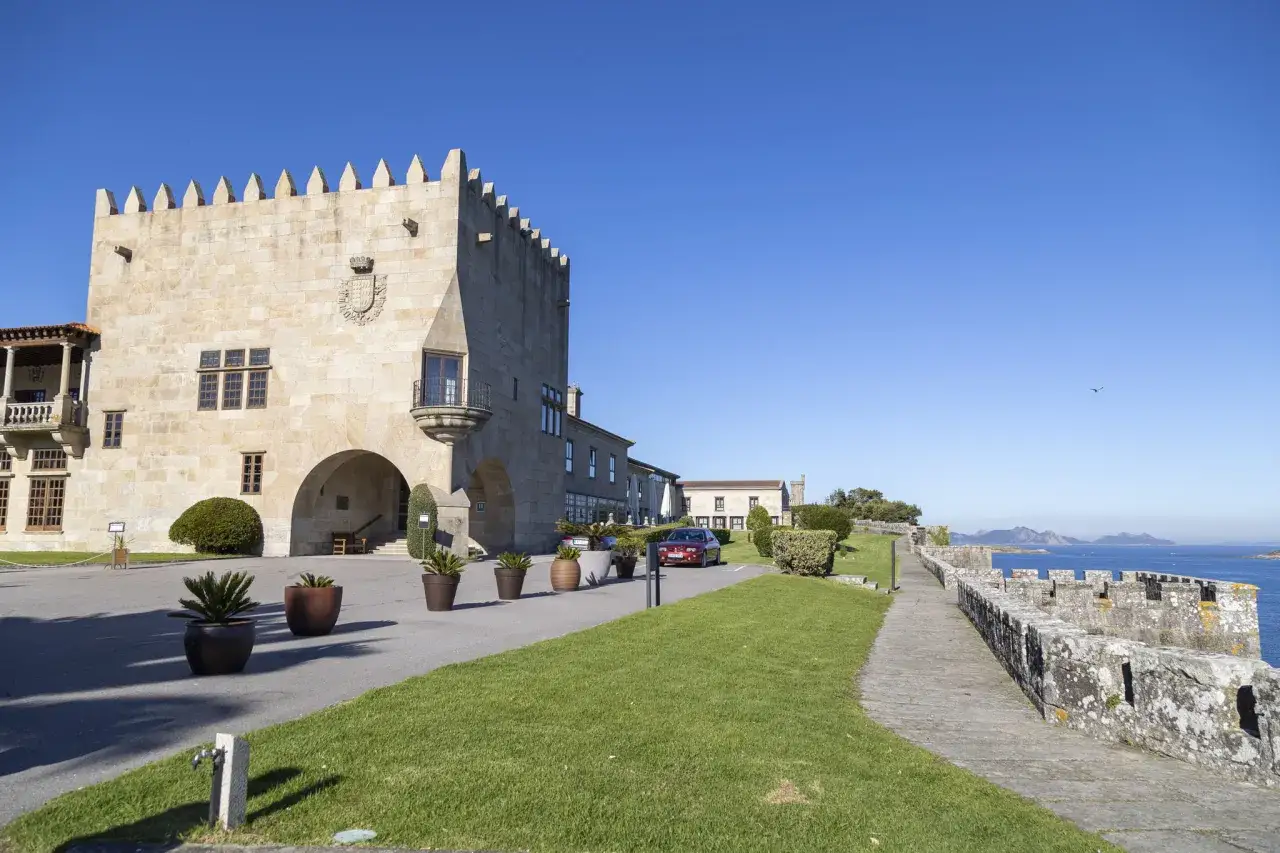 A historic stone fortress with crenellated battlements overlooks the sea in Baiona, Portugal.