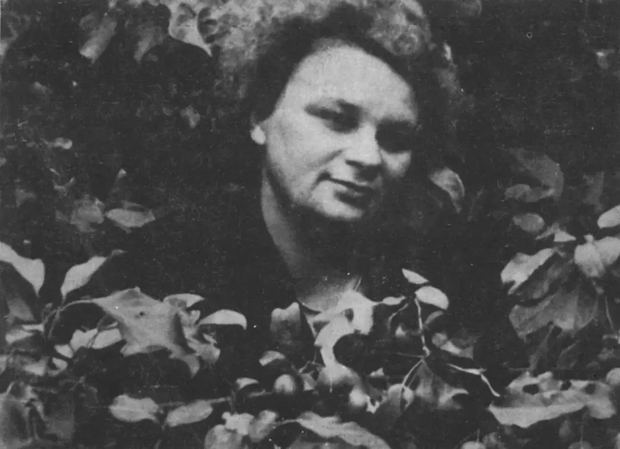 Portret Anny Kamieńskiej, otoczonej liśćmi i owocami, jakby w symbolicznym