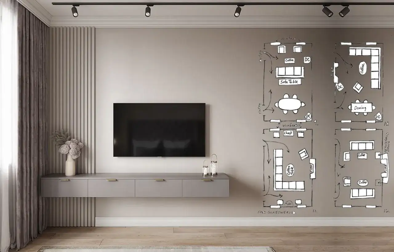 Un soggiorno moderno con un mobile TV sospeso e schizzi di planimetrie sul muro. La disposizione del tv non frontale al divano è una delle opzioni studiate.