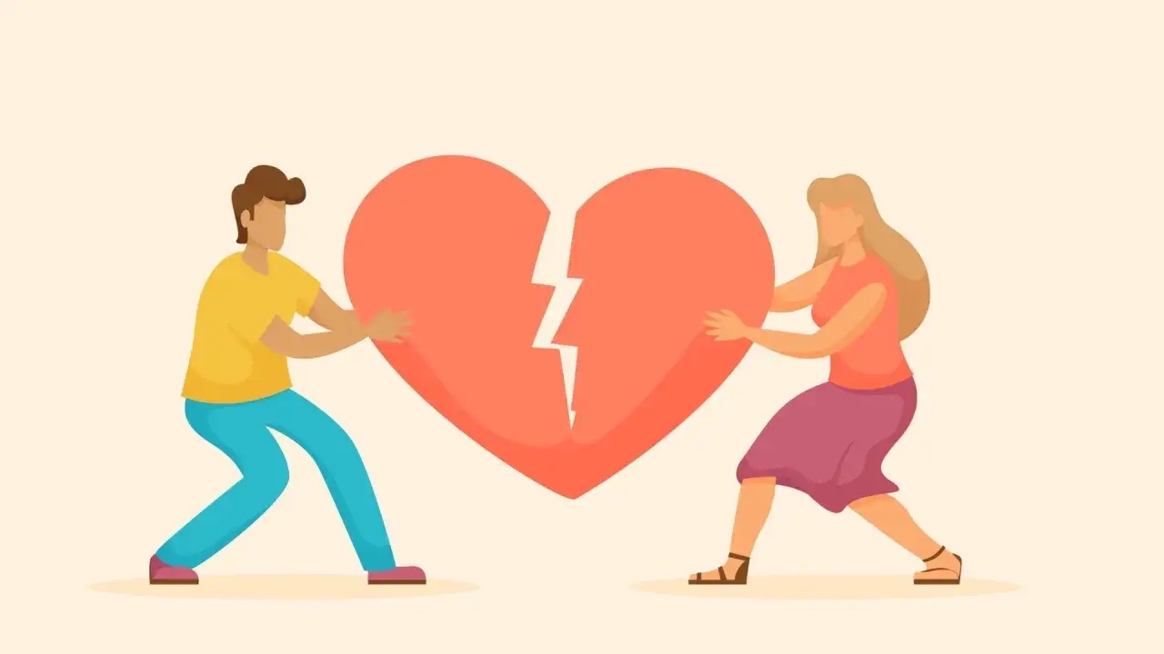 Coppia che separa un cuore spezzato, un chiaro segnale, una red flag, che indica la fine di una relazione.
