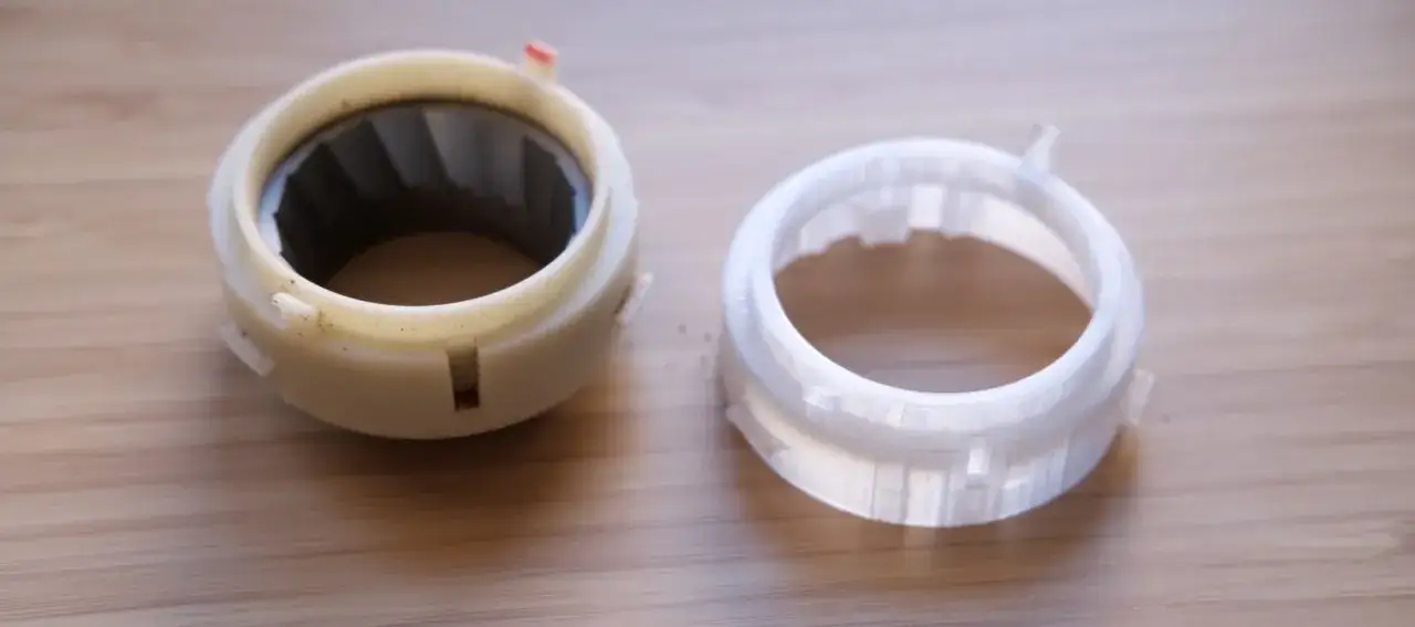 A worn coffee grinder part next to a newly 3D printed replacement. This shows what you can do with a 3D printer: repair and customize everyday items.