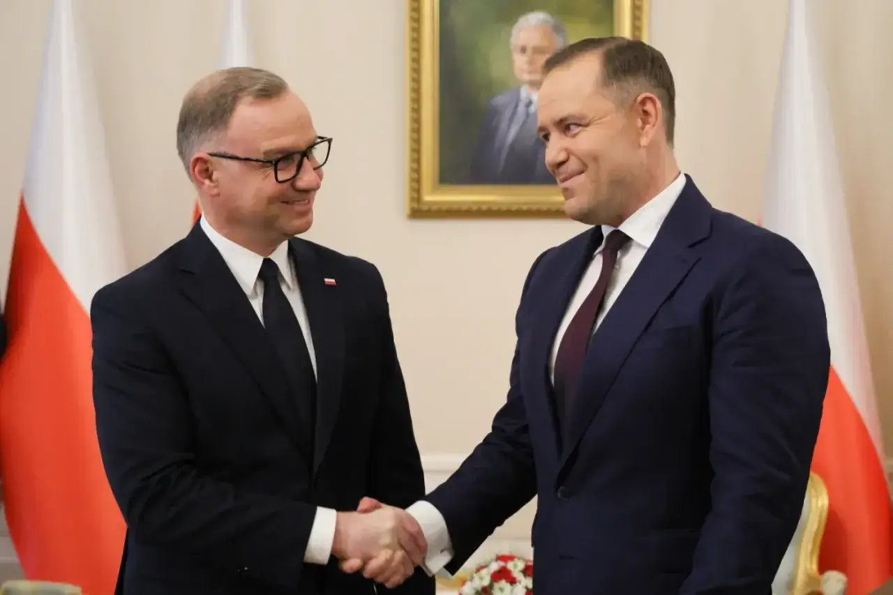 Dwóch polityków w garniturach ściska sobie dłonie. Dyskusja o tym, ile trwa kadencja prezydenta, jest ważna dla przyszłości kraju.