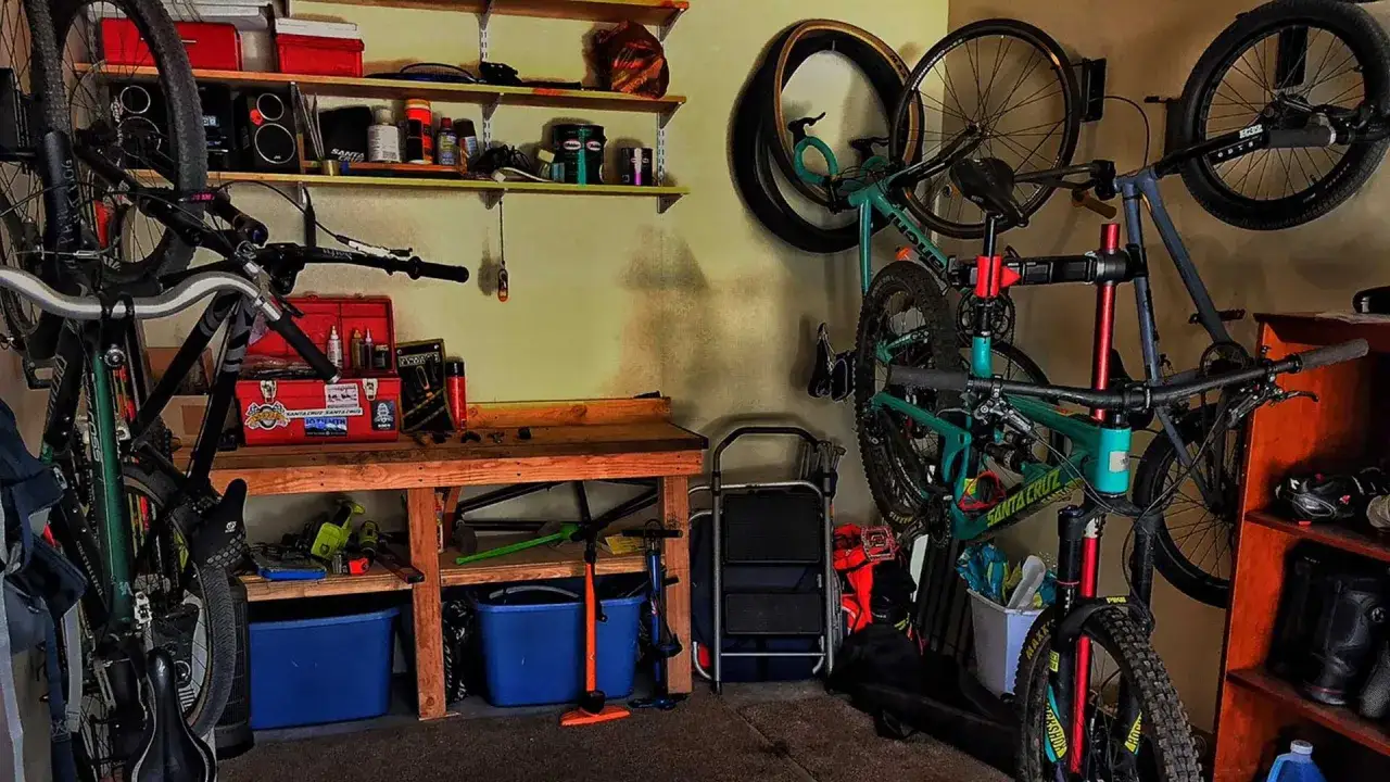 A workshop with bikes hanging and on stands, tools, and supplies. This is where you'd learn how to build a mountain bike.