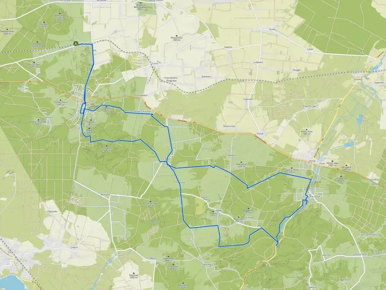 Mapa z zaznaczonymi szlakami rowerowymi wokół Olsztyna, prowadzącymi przez lasy i tereny pagórkowate.