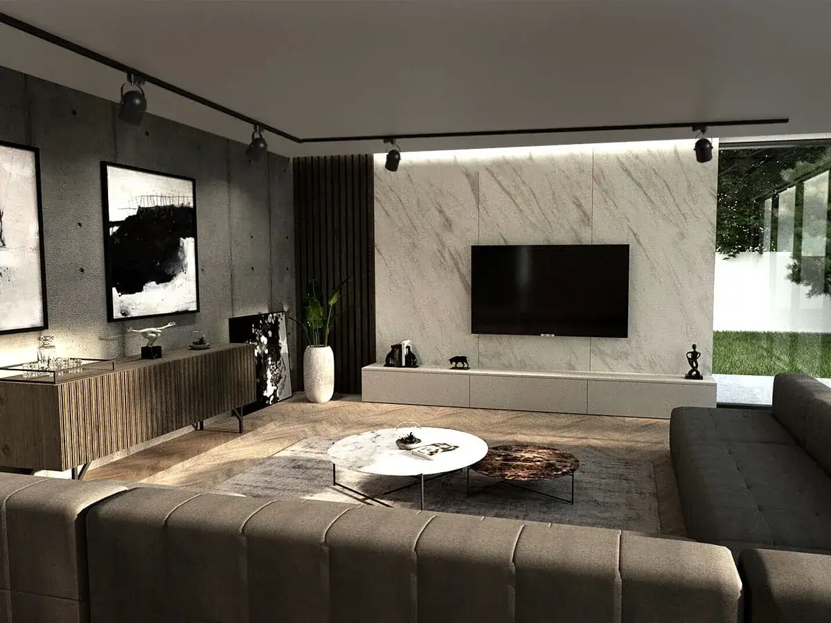 Nowoczesny salon z betonową ścianą, na której wisi obraz. Lampa szyna oświetla wnętrze, a obok stoi telewizor.