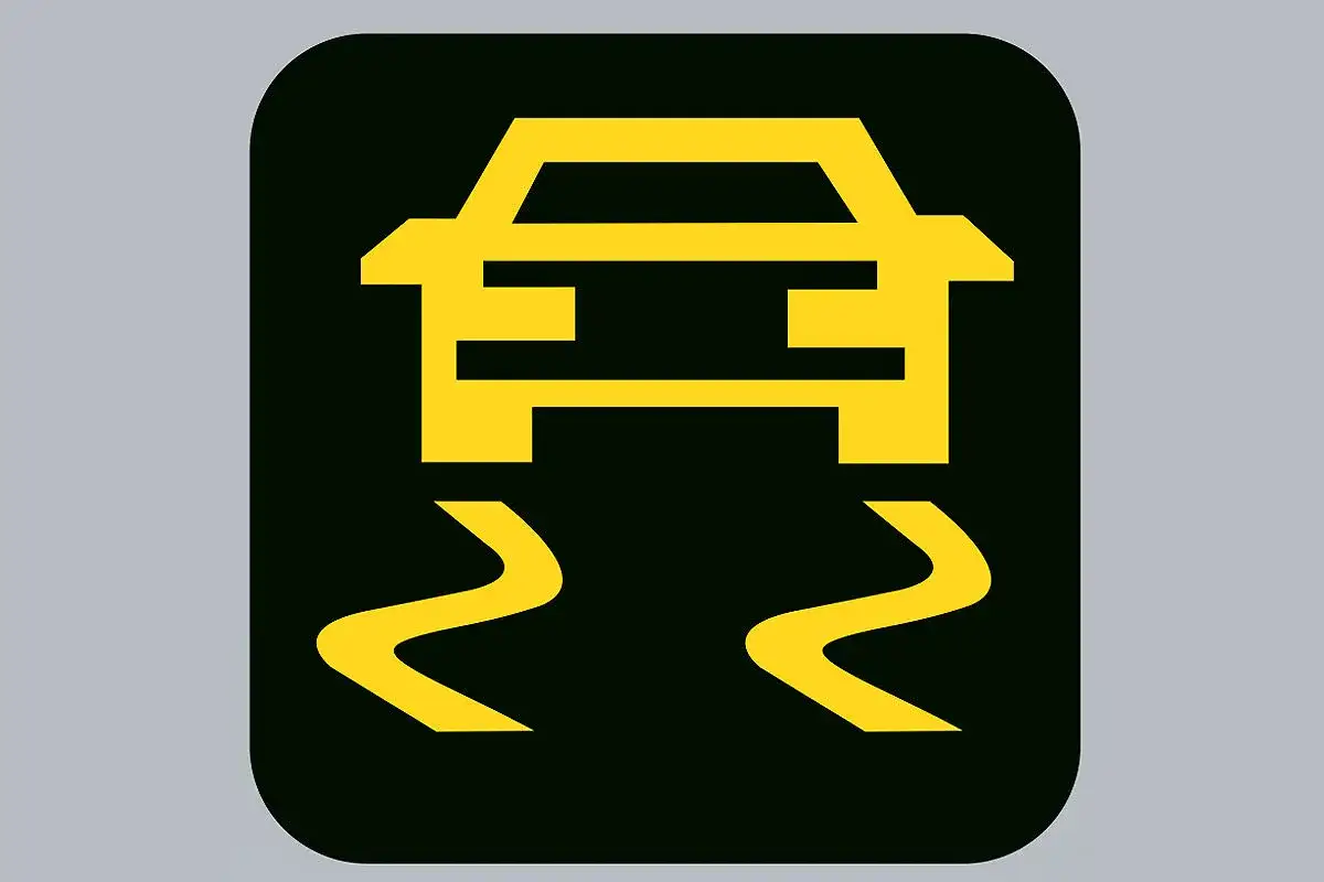 Gelbes Warnsymbol für ESP/ASR bei einem Renault, das auf rutschiger Fahrbahn hinweist.
