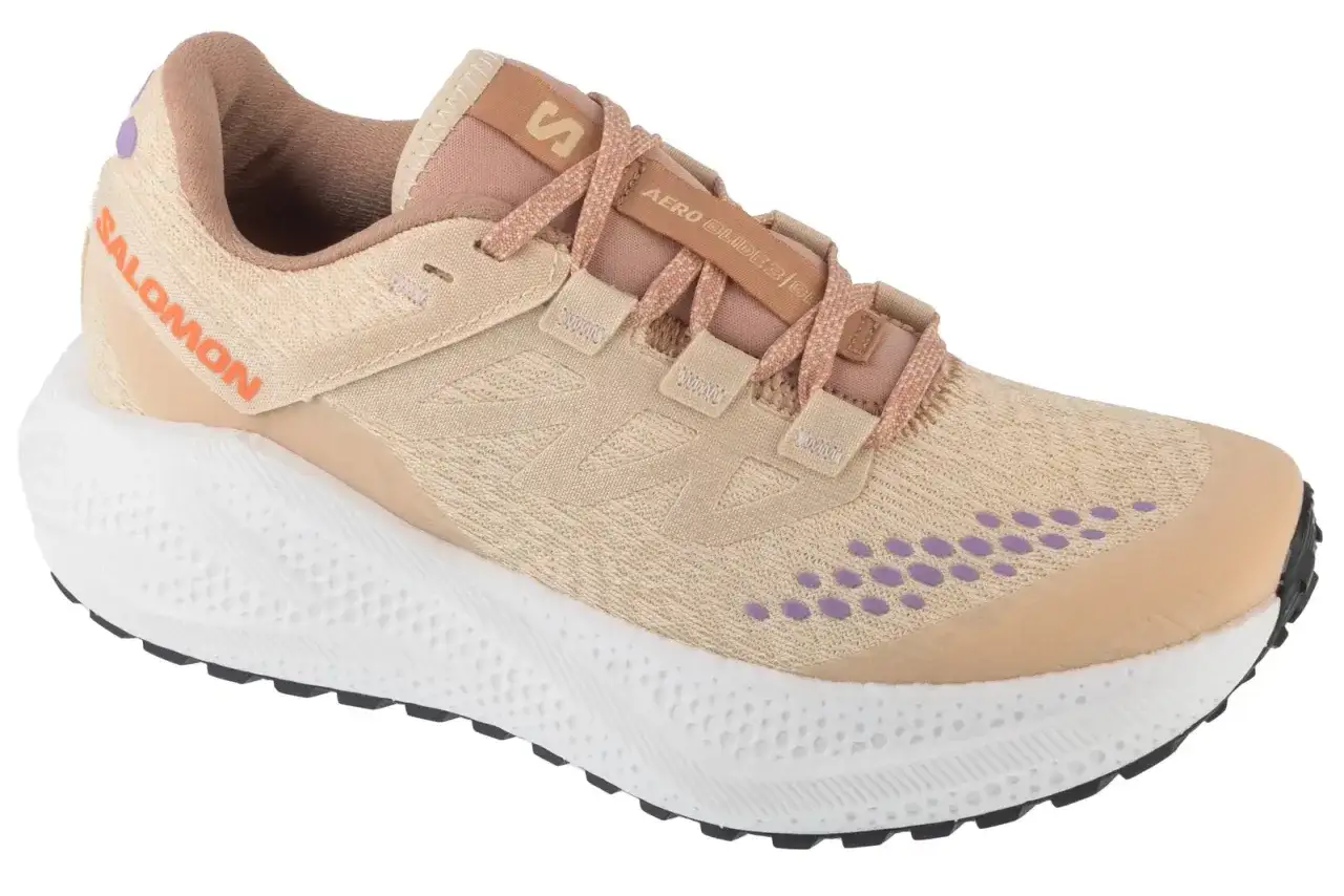 Beżowe buty do biegania Salomon Aero Glide 3 z fioletowymi akcentami i białą podeszwą.