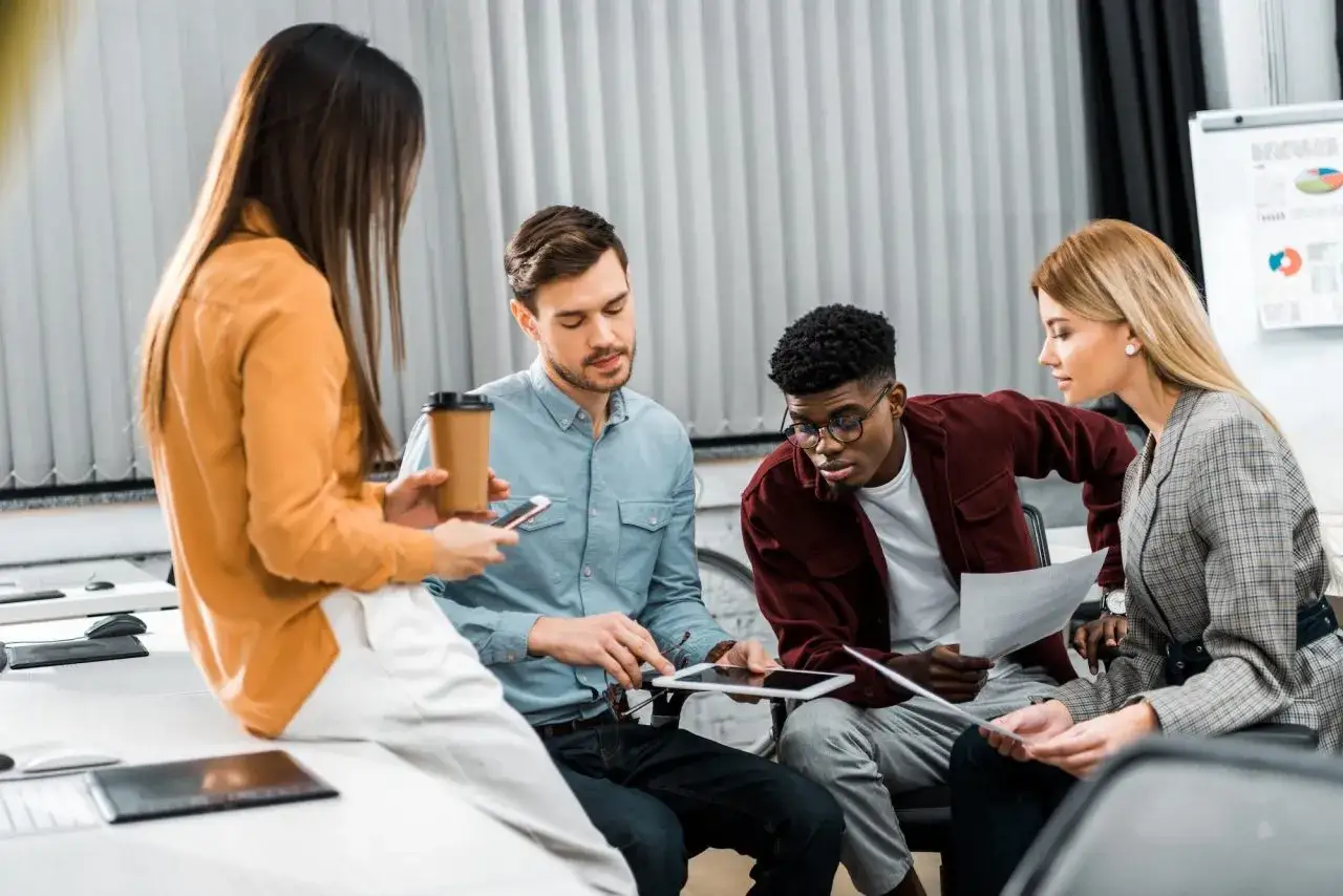 A diverse team collaborates on a project, showing that diversity is important for innovation and problem-solving.