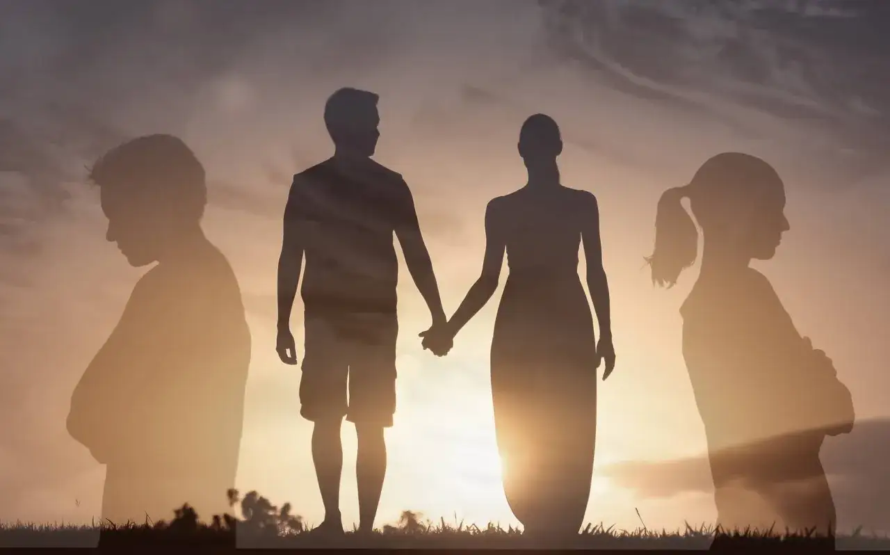 Silhouettes d'un couple se tenant la main, entourés par des figures isolées, symbolisant la séparation de corps et de bien.