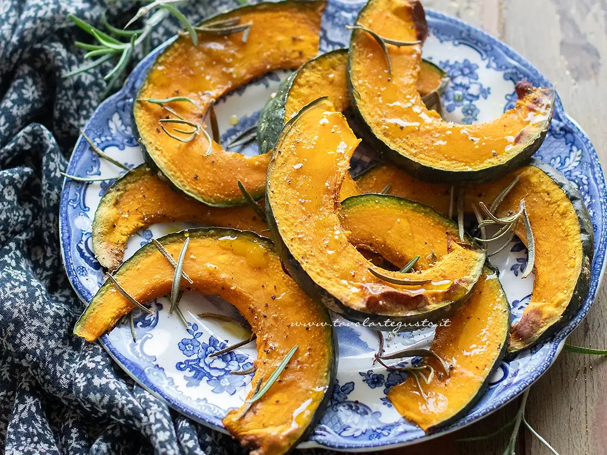Fette di zucca in friggitrice ad aria, dorate e profumate al rosmarino, servite su un piatto decorato.