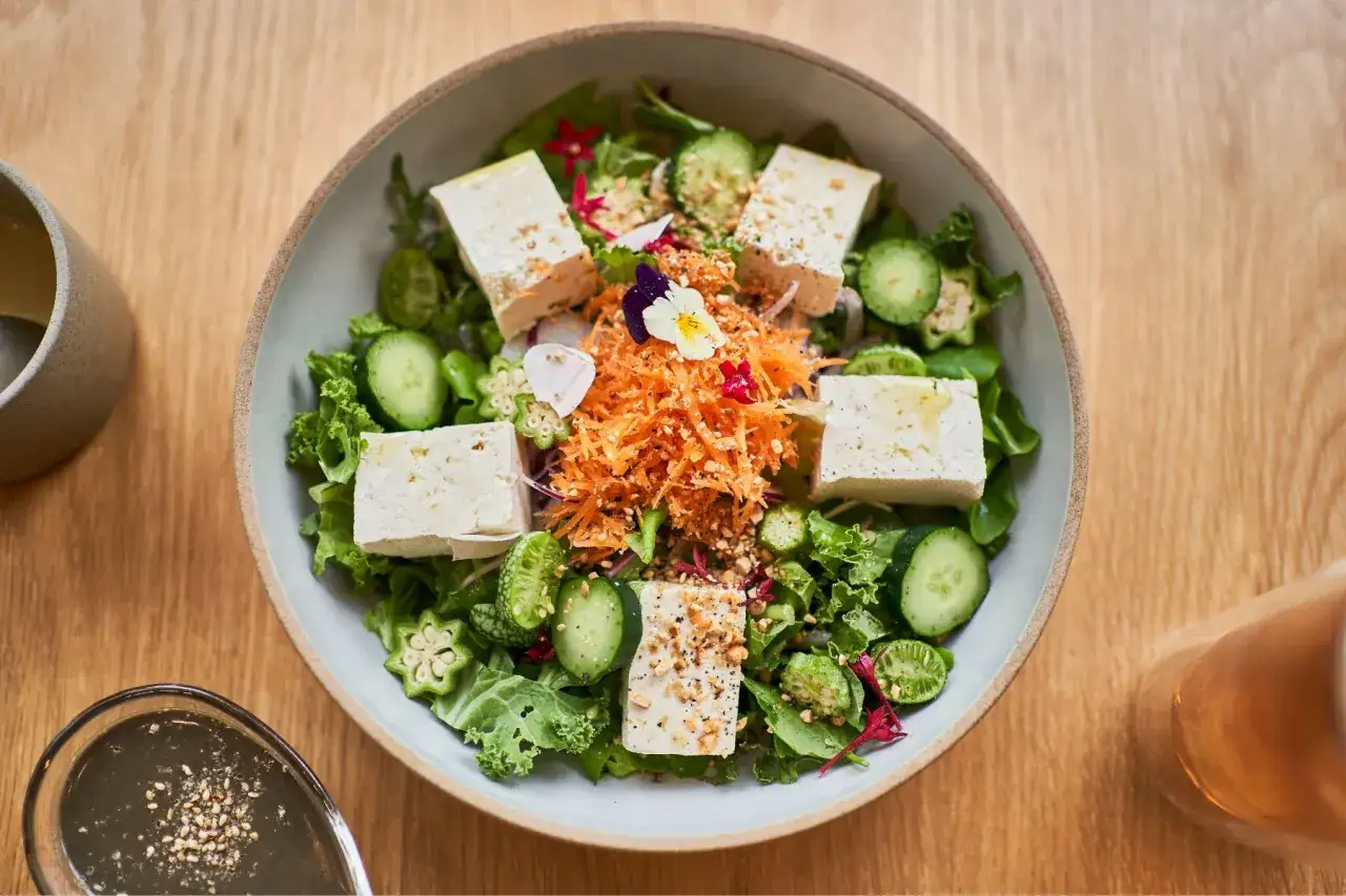 Insalata colorata con cubetti di tofu, carote, cetrioli e okra. Un piatto che aiuta a capire quanta leucina al giorno &egrave; ideale per il benessere.
