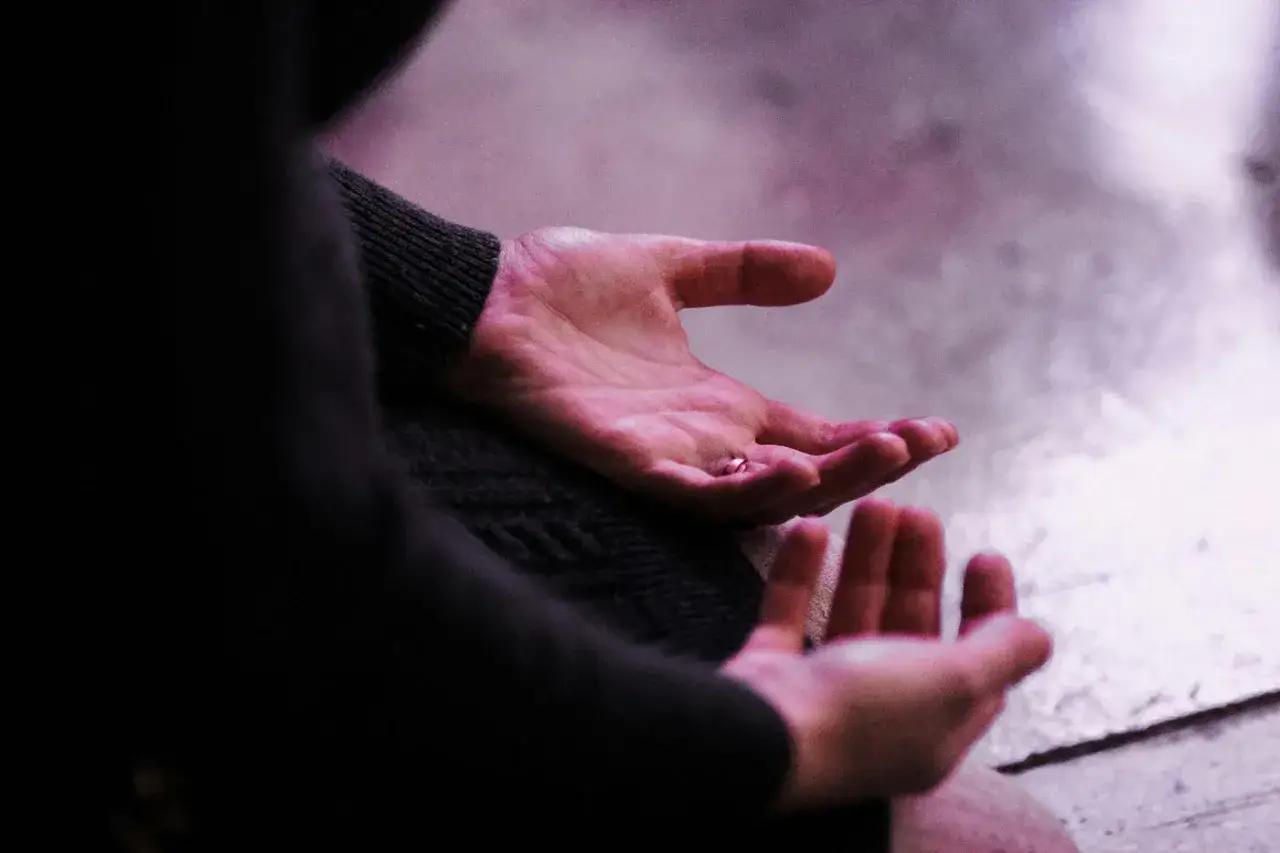 Hands open, palms up, offering a tiny bead. A moment of surrender, to give it to God.
