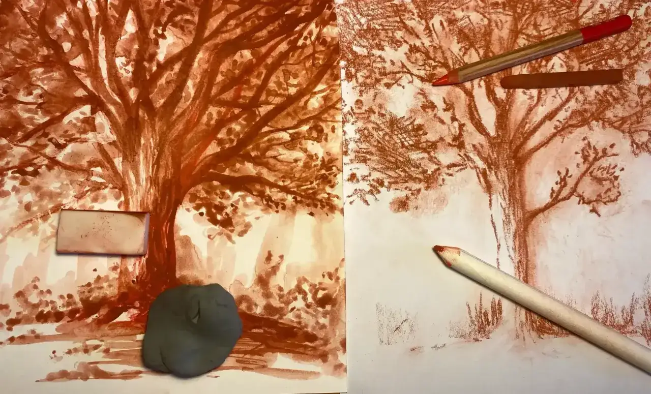 Deux feuilles montrent un arbre en cours de dessin à la sanguine. Un crayon et une gomme sont posés sur le papier, suggérant un dessin sanguine facile.