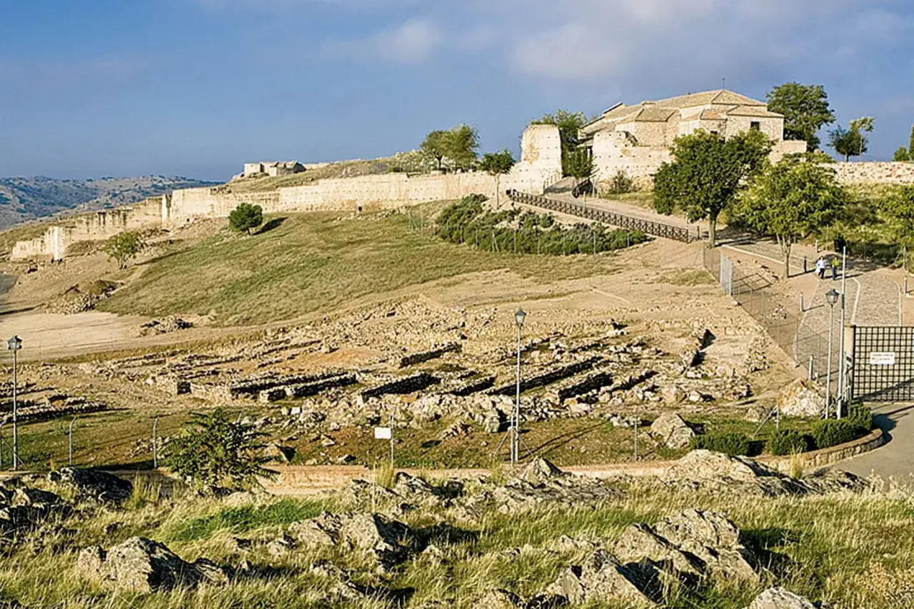 Ruinas de una antigua ciudad real que ver, con murallas y edificios históricos en una colina.
