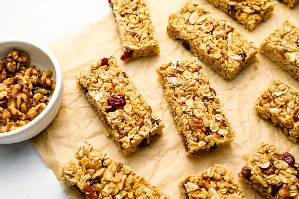 Barres de céréales maison, parfaites pour une recette barre de céréales healthy. Noix et fruits secs visibles.