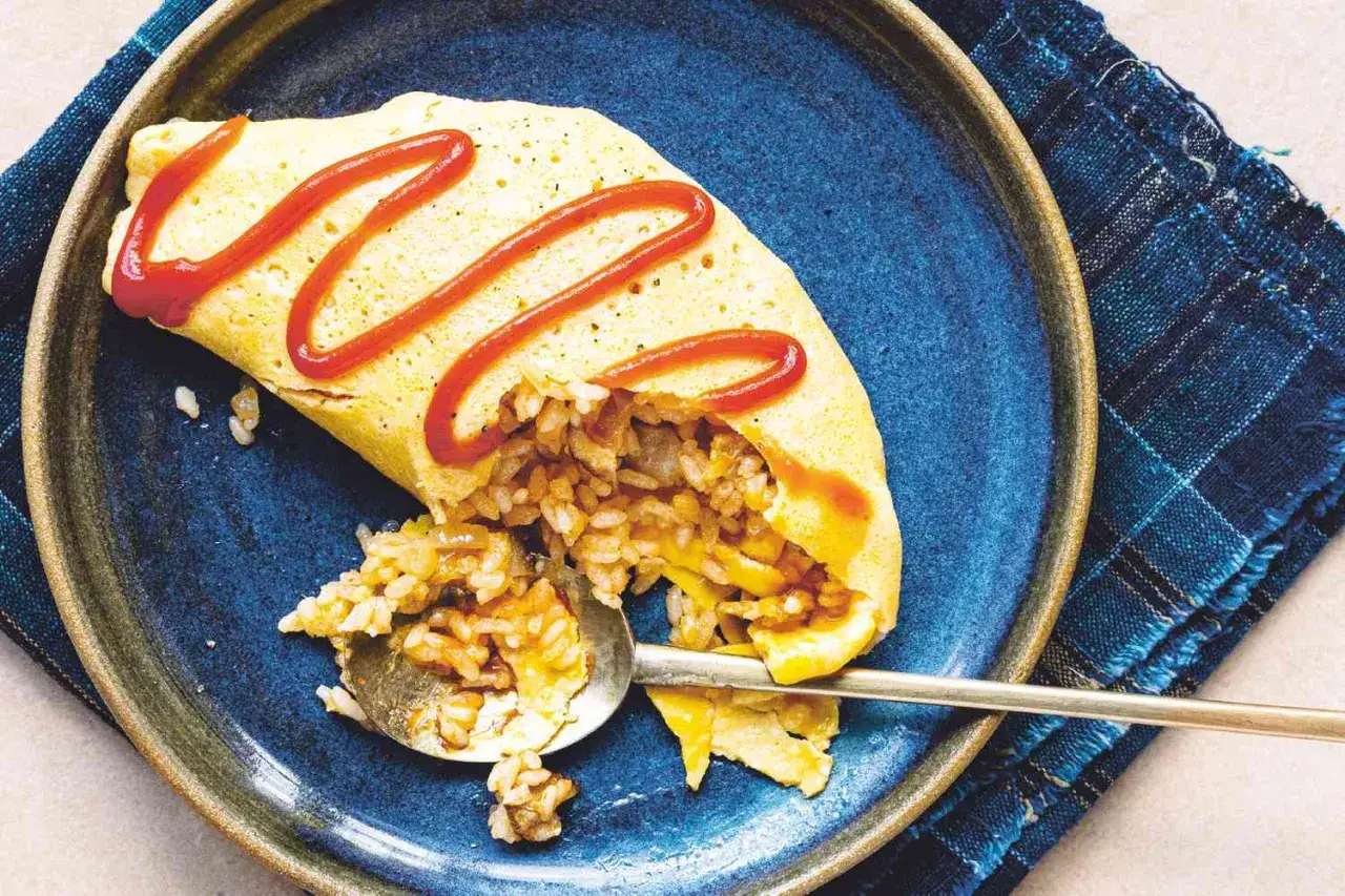 A delicious omurice, a Japanese omelet with fried rice, drizzled with ketchup. Wondering about omurice calories? This dish is a satisfying meal.