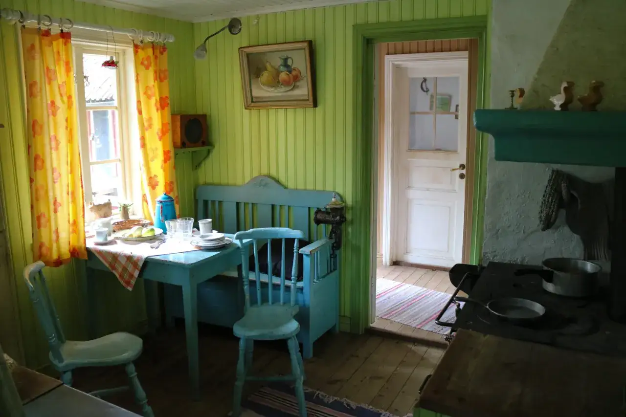 Julita gård, Pettson och Findus kök. Ett charmigt kök med ljusgröna väggar, blå möbler och en öppen dörr.