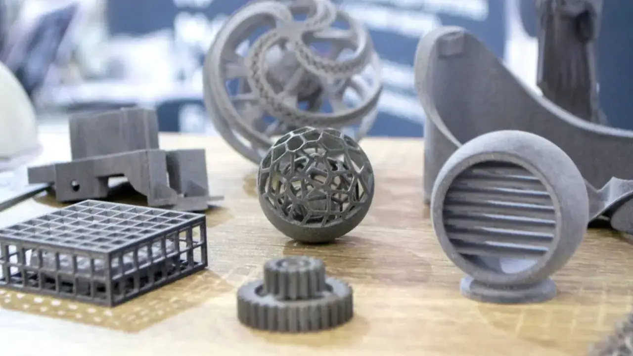 Intricate 3d printing spare parts, including a geodesic sphere, gears, and a lattice cube, showcase the precision of modern manufacturing.