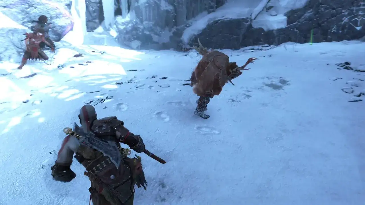 Kratos walczy z potworem w śnieżnym terenie. To scena z gry God of War Ragnarok poradnik.
